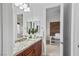Bathroom with granite countertops, stylish wood cabinets, and a view of a bedroom through the doorway at 8209 Chapelle Ct, Las Vegas, NV 89131