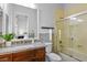 Bathroom with granite countertops, wood cabinets, and a shower/tub combo with glass doors at 8209 Chapelle Ct, Las Vegas, NV 89131