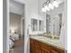 Bathroom featuring granite countertops, wood cabinets, and an open doorway leading to a bedroom at 8209 Chapelle Ct, Las Vegas, NV 89131