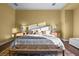 Stylish bedroom with soft, neutral walls, a seating bench, and hardwood floors at 8209 Chapelle Ct, Las Vegas, NV 89131