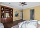 Bright bedroom featuring wood floors, soft walls, and built-in wood bookcase at 8209 Chapelle Ct, Las Vegas, NV 89131
