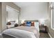 Comfortable bedroom with a mirrored closet, a cozy bed with stylish pillows and bedside tables at 8209 Chapelle Ct, Las Vegas, NV 89131