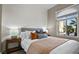 Cozy bedroom featuring a comfortable bed, bedside tables with lamps, and a bright window view at 8209 Chapelle Ct, Las Vegas, NV 89131