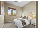 Bright bedroom with neutral tones, comfortable bed, and a window offering natural light at 8209 Chapelle Ct, Las Vegas, NV 89131