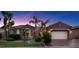 Charming single-story home featuring stone accents, a two-car garage, and well-manicured landscaping at 8209 Chapelle Ct, Las Vegas, NV 89131
