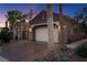 Exterior view showcasing a two-car garage with a concrete driveway and desert landscaping at 8209 Chapelle Ct, Las Vegas, NV 89131