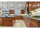Spacious kitchen featuring custom wood cabinets, granite countertops, tile backsplash, and modern appliances at 8209 Chapelle Ct, Las Vegas, NV 89131