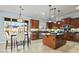 Open kitchen with an island, stainless appliances, and dining table with backyard view at 8209 Chapelle Ct, Las Vegas, NV 89131