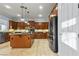 Modern kitchen with stainless steel appliances, tile flooring, and a large center island at 8209 Chapelle Ct, Las Vegas, NV 89131