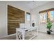 Bright office space featuring a wooden accent wall, a modern desk, and a window with natural light at 8209 Chapelle Ct, Las Vegas, NV 89131