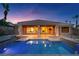 Backyard showcasing a private pool, covered patio, and stone accents on the home's exterior at 8209 Chapelle Ct, Las Vegas, NV 89131