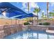 Beautiful swimming pool and spa area featuring sun loungers and tropical landscaping under blue skies at 8209 Chapelle Ct, Las Vegas, NV 89131