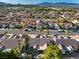 Overhead view of a well-maintained neighborhood with lush landscaping, palm trees, and mountain views at 8537 Highland View Ave, Las Vegas, NV 89145