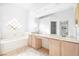 Bathroom with double sinks, large mirrors, a soaking tub, and tiled flooring at 8537 Highland View Ave, Las Vegas, NV 89145