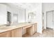 Bathroom featuring dual sinks, a large mirror, and a separate shower enclosure at 8537 Highland View Ave, Las Vegas, NV 89145