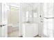 Bright bathroom with a single sink, large mirror, and separate tub with shower at 8537 Highland View Ave, Las Vegas, NV 89145