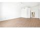 Open bedroom with hardwood flooring, white walls, and an open doorway to other rooms at 8537 Highland View Ave, Las Vegas, NV 89145