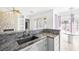 Modern kitchen with granite countertops open to the living spaces at 8537 Highland View Ave, Las Vegas, NV 89145