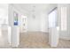 Open-concept living area with elegant chandelier, neutral tile flooring, and bright windows at 8537 Highland View Ave, Las Vegas, NV 89145