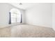 Bright living area with large arch window, neutral tile flooring, and neutral paint at 8537 Highland View Ave, Las Vegas, NV 89145