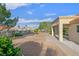This view of the backyard shows the covered patio, low maintenance landscaping, and mature trees at 8924 Signal Terrace Dr, Las Vegas, NV 89134