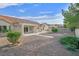 A view of the rear exterior of a single-story home with low maintenance landscaping and mature shrubbery at 8924 Signal Terrace Dr, Las Vegas, NV 89134