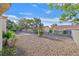 The landscaped backyard has mature trees, shrubs, and a low-maintenance desert landscape at 8924 Signal Terrace Dr, Las Vegas, NV 89134
