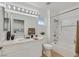 Bright bathroom with white cabinets, marble counters, and updated shower with tub at 8924 Signal Terrace Dr, Las Vegas, NV 89134