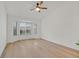 Bedroom with bay window has wood floors, and a ceiling fan at 8924 Signal Terrace Dr, Las Vegas, NV 89134
