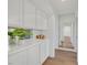 Hallway features built-in cabinets with decorative decor and wood floors at 8924 Signal Terrace Dr, Las Vegas, NV 89134