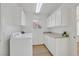 Practical laundry room featuring updated appliances, storage cabinets, and bright lighting at 8924 Signal Terrace Dr, Las Vegas, NV 89134