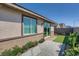 Exterior view of backyard with artificial grass and a wooden deck, perfect for outdoor living at 9357 Aria Ridge Ave, Las Vegas, NV 89143