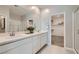 Bathroom featuring a double sink vanity, quartz countertop, and walk-in shower at 9357 Aria Ridge Ave, Las Vegas, NV 89143