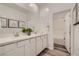 Bathroom featuring a double sink vanity, quartz countertop, and a tub and shower at 9357 Aria Ridge Ave, Las Vegas, NV 89143