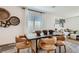 Open-concept dining area featuring contemporary decor and seamlessly flowing into the living space at 9357 Aria Ridge Ave, Las Vegas, NV 89143