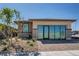 Inviting single-story home boasts desert landscaping and sliding glass doors at 9357 Aria Ridge Ave, Las Vegas, NV 89143