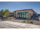 Modern single-story home featuring desert landscaping, brick drive, and sliding glass doors at 9357 Aria Ridge Ave, Las Vegas, NV 89143