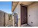 Welcoming covered front entry with a dark paneled front door and side access gate at 9357 Aria Ridge Ave, Las Vegas, NV 89143