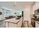 Open concept kitchen that seamlessly flows into the dining and living area for easy entertaining at 9357 Aria Ridge Ave, Las Vegas, NV 89143