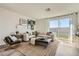 Spacious living room featuring a large window and comfortable sectional sofa at 9357 Aria Ridge Ave, Las Vegas, NV 89143