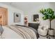 Well-lit main bedroom with stylish decor, including a decorative mirror and comfortable seating area at 9357 Aria Ridge Ave, Las Vegas, NV 89143