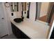 Bathroom vanity with dark wood cabinets, quartz countertop and black vessel sink at , Las Vegas, NV 89130