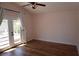 A bright bedroom with hardwood flooring, ceiling fan, and elegant curtains at , Las Vegas, NV 89130