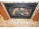 Close-up of the fireplace featuring a stone surround, decorative logs, and a tiled hearth at , Las Vegas, NV 89130