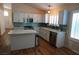 Bright kitchen features white cabinets, stainless steel appliances, a kitchen island and teal backsplash at , Las Vegas, NV 89130