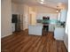 Open kitchen with white cabinets, stainless steel appliances, a kitchen island and teal backsplash at , Las Vegas, NV 89130