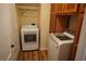 Convenient laundry room with wood floors, washer, dryer, storage cabinets, and closet at , Las Vegas, NV 89130