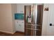 Stainless steel refrigerator with white cabinets and teal backsplash at , Las Vegas, NV 89130