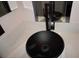 Bathroom features black vessel sink and modern fixtures on a speckled countertop at , Las Vegas, NV 89130