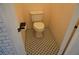 Traditional toilet in a bathroom with black and white patterned tile floor at , Las Vegas, NV 89130